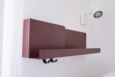 a shelf on a wall with a clock on it at VILLA LINA - sky earth liberty villa - 5 min from tube in Rome