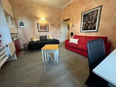 a living room with a red couch and a table at Domus Musei Vaticani Roma Centro 