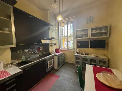 a kitchen with black cabinets and a table in it at Domus Musei Vaticani Roma Centro 