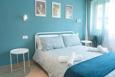 a blue bedroom with a bed with stuffed animals on it at Charming Apartment Gregory in Rome