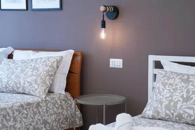 a bedroom with a bed and a table and a lamp at Charming Apartment Gregory in Rome