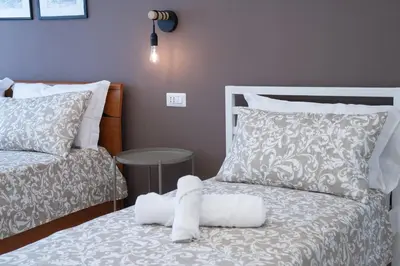 a bedroom with a bed with a stuffed animal on it at Charming Apartment Gregory in Rome