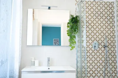 a bathroom with a sink and a mirror and a shower at Charming Apartment Gregory in Rome