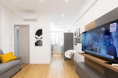 a living room with a large flat screen tv at GES House Roma in Rome
