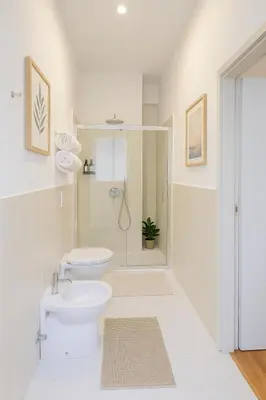 a white bathroom with a toilet and a shower at Flaminia Design Apartment - GR HOME in Rome