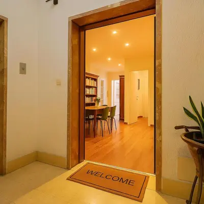 a door to a dining room with a welcome mat at Flaminia Design Apartment - GR HOME in Rome