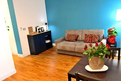 a living room with a couch and a table at At Home Montebello in Rome