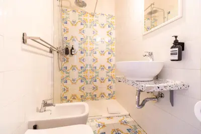 a bathroom with a sink and a toilet at Joe Litty Rooms in Rome