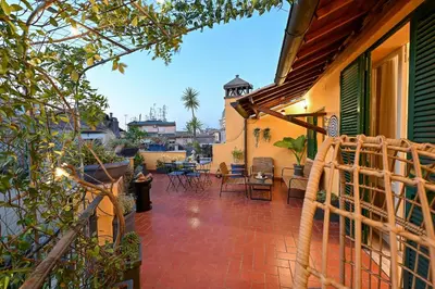 a patio with chairs and tables on a house at Navona design rooftop in Rome