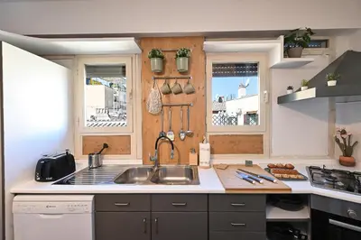a kitchen with a sink and two windows at Navona design rooftop in Rome