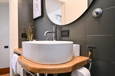 a bathroom with a white sink and a mirror at Navona design rooftop in Rome
