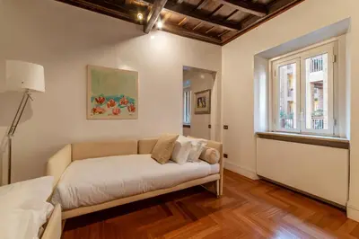 a living room with a couch and a window at Frezza 39b - FromeHometoRome in Rome