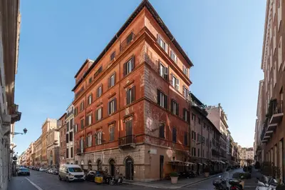 a red brick building on the side of a street at Frezza 39b - FromeHometoRome in Rome