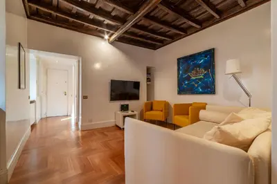 a living room with a couch and a tv at Frezza 39b - FromeHometoRome in Rome