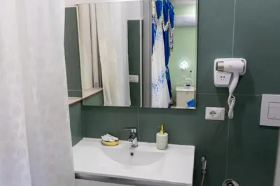 a bathroom with a sink and a mirror at La Dolce Casa in Rome