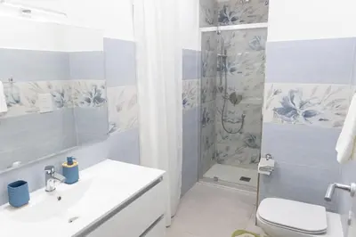 a bathroom with a toilet sink and a shower at La Dolce Casa in Rome