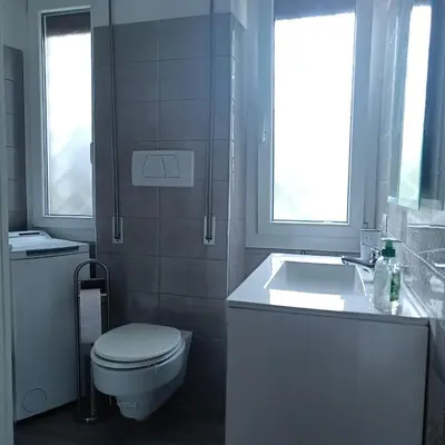 a white bathroom with a toilet and a sink at Vatican Museums Balcony Apartment - Fast Wi-Fi & Metro Nearby in Rome