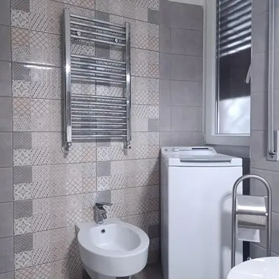 a small bathroom with a sink and a toilet at Vatican Museums Balcony Apartment - Fast Wi-Fi & Metro Nearby in Rome