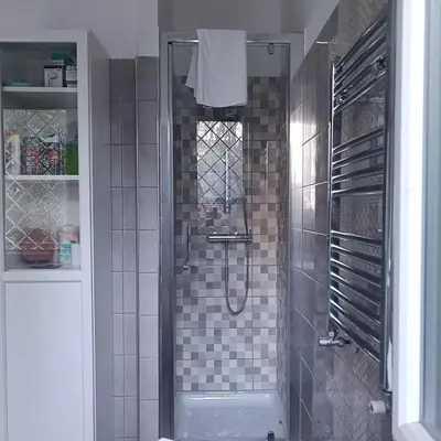 a bathroom with a shower with a glass door at Vatican Museums Balcony Apartment - Fast Wi-Fi & Metro Nearby in Rome