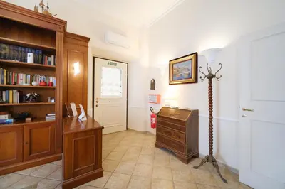 a room with a desk and a book shelf at La Casa del Capitano by BuddyRent in Rome