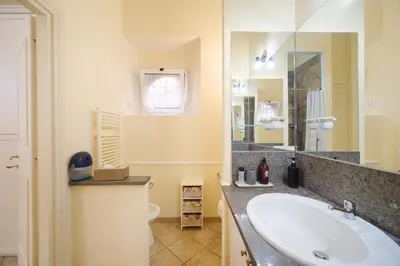 a bathroom with a sink and a toilet at La Casa del Capitano by BuddyRent in Rome