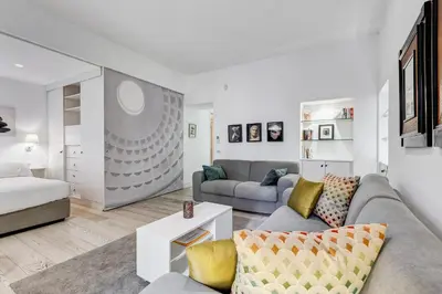 a living room with a couch and a bed at Barberini - FromHometoRome in Rome