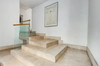 a staircase in a room with a picture on the wall at Barberini - FromHometoRome in Rome