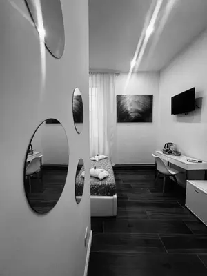 a small bedroom with a bed and a desk at Pantheon 15 in Rome