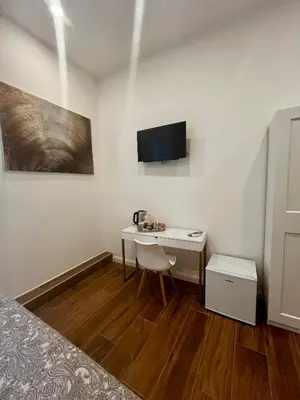 a room with a bed and a desk and a mirror at Pantheon 15 in Rome