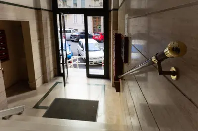 a light on the door of a building with a car at Nextovatican Apartment in Rome