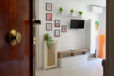 a living room with a tv on a wall at Nextovatican Apartment in Rome