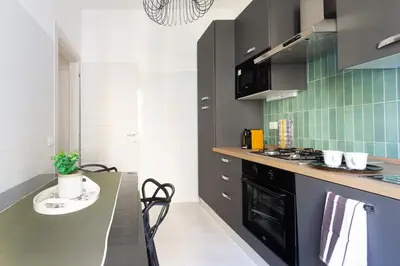 a kitchen with a black stove and a counter at Nextovatican Apartment in Rome