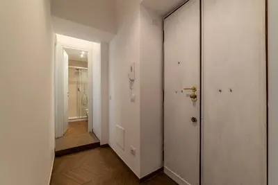 a hallway with white walls and a white door at Testaccio - FromHometoRome in Rome
