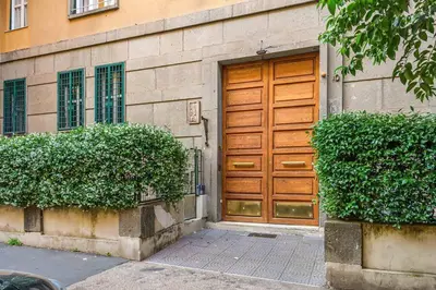 a wooden door on the side of a building at Riboty 10 Suites in Rome