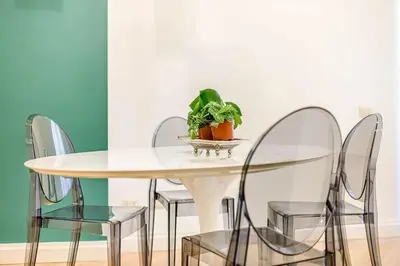 a table with four chairs and a potted plant on it at Riboty 10 Suites in Rome