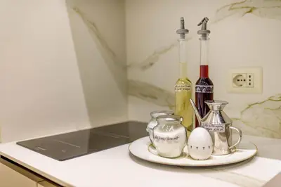 a counter with a plate with an egg and two bottles of wine at Riboty 10 Suites in Rome