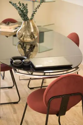 a glass table with a laptop on top of it at Tasso Designer Suite - Colosseum Esquilino in Rome