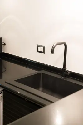 a kitchen sink with a faucet on a counter at Tasso Designer Suite - Colosseum Esquilino in Rome