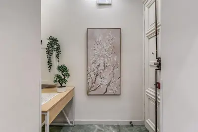 a room with a desk and a painting on the wall at Adriana 5 Luxury rooms in Rome