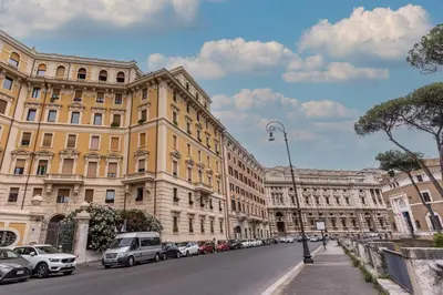 a street with cars parked in front of buildings at Adriana 5 Luxury rooms in Rome