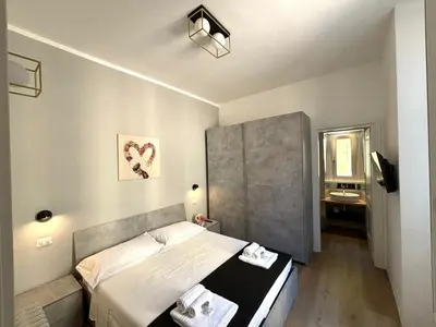 a small bedroom with a bed and a bathroom at Liberty Home in Rome