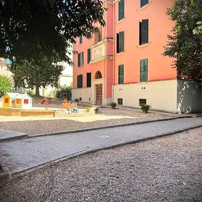 a large building with a clock on the side of it at Liberty Home in Rome