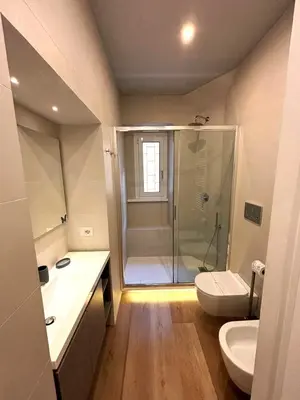 a bathroom with a shower and a toilet and a sink at Liberty Home in Rome