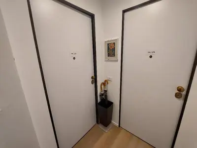 a hallway with two white doors and a wooden floor at Liberty Home in Rome