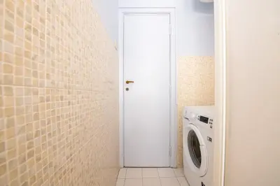 a laundry room with a washer and dryer at Magiù Apartment in Rome