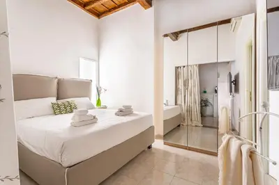 a bedroom with a large bed and a bath tub at iFlat Comfy apt a few steps from the Vatican in Rome