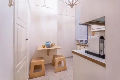a small kitchen with two stools and a microwave at iFlat Comfy apt a few steps from the Vatican in Rome