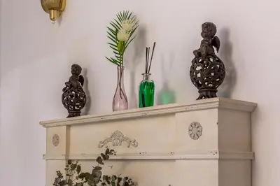 a shelf with three vases on top of it at iFlat Comfy apt a few steps from the Vatican in Rome