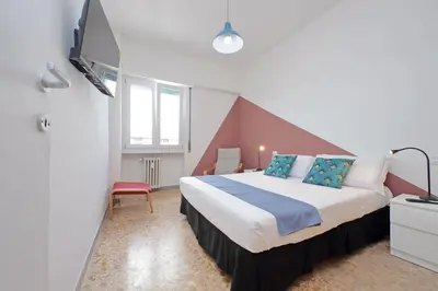 a bedroom with a large bed and a tv at Comfy home for family next to Metro in Rome