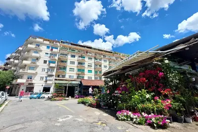 a large building with flowers in front of it at Comfy home for family next to Metro in Rome